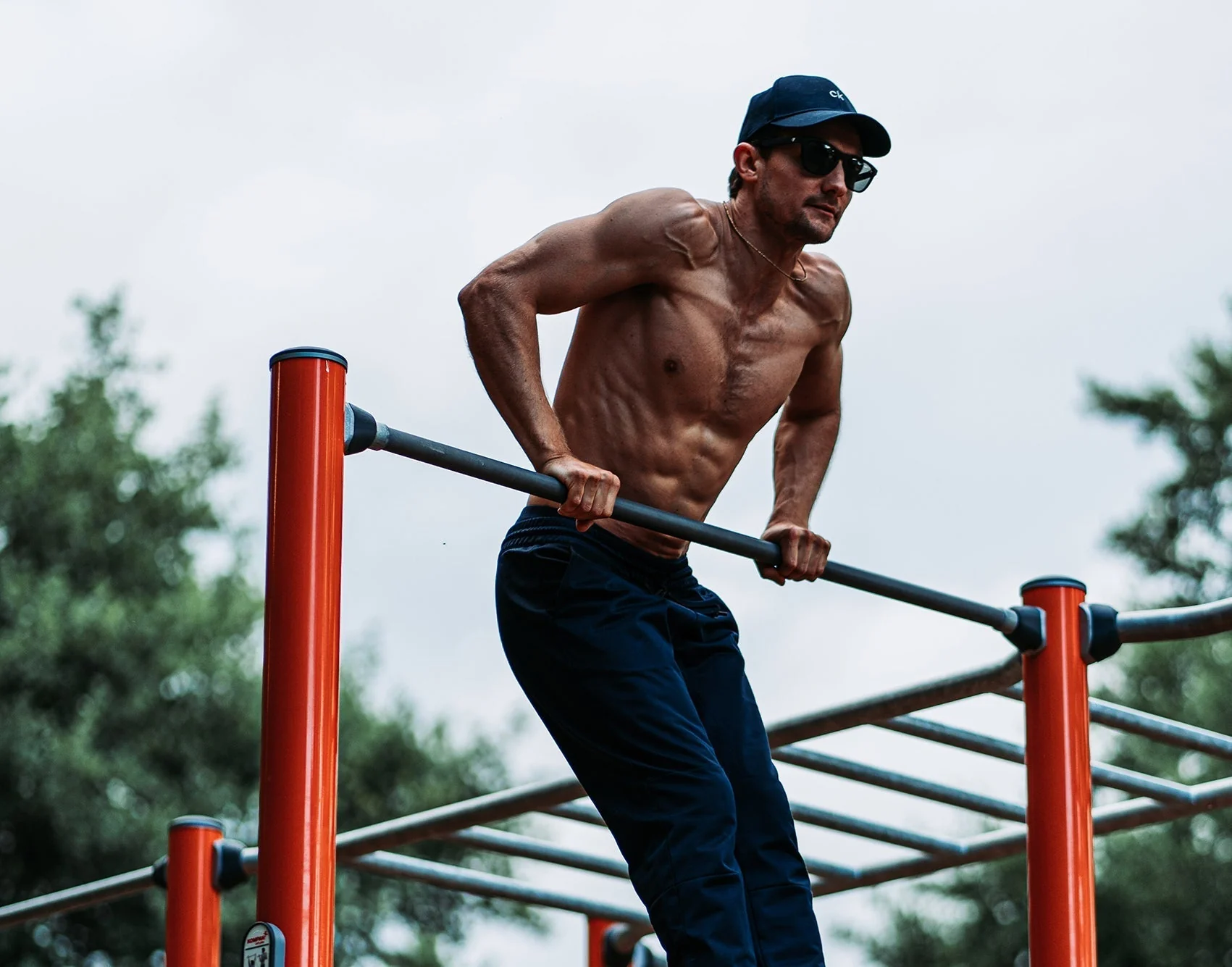 Athlete doing dips on outdoor calisthenics bars